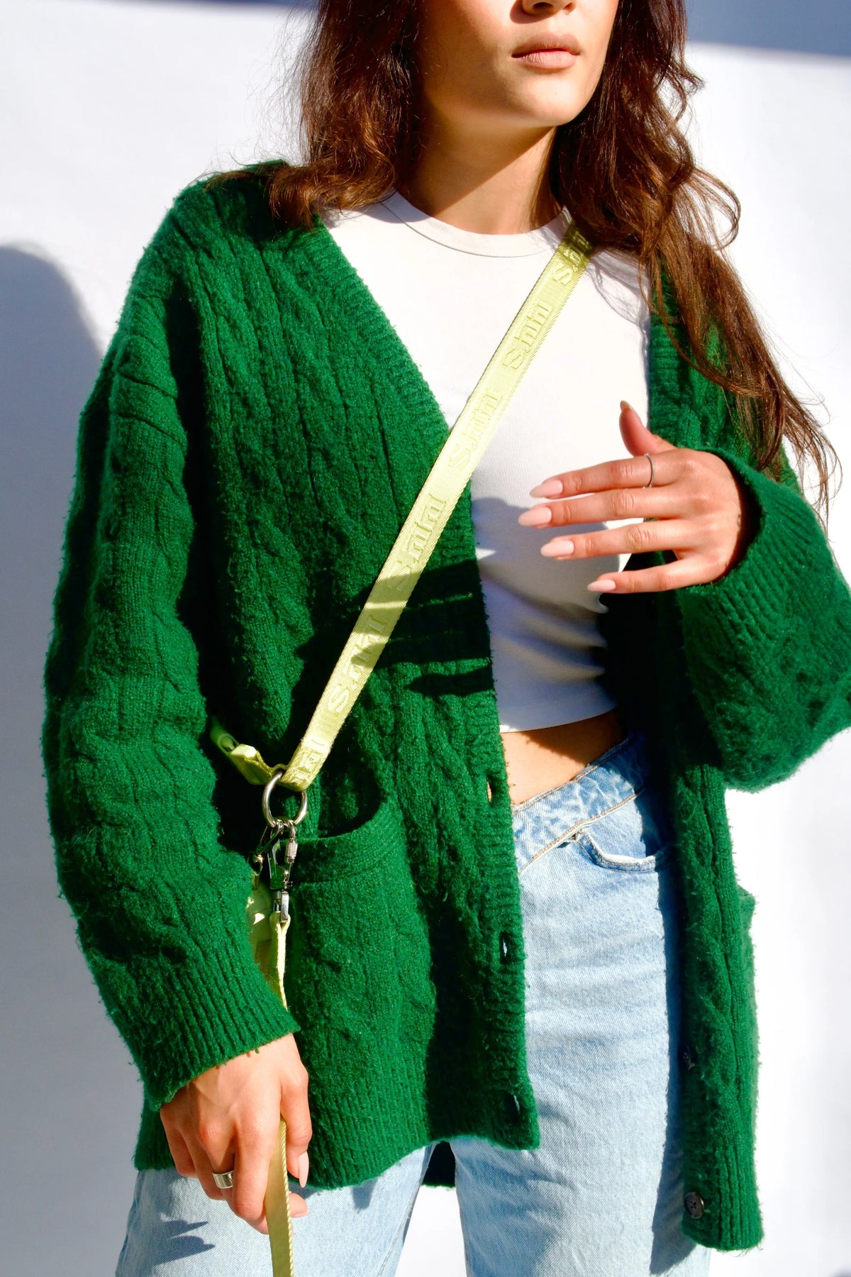 Woman in a green cardigan wearing a Matcha Green Lulu's from Cali walking belt crossbody