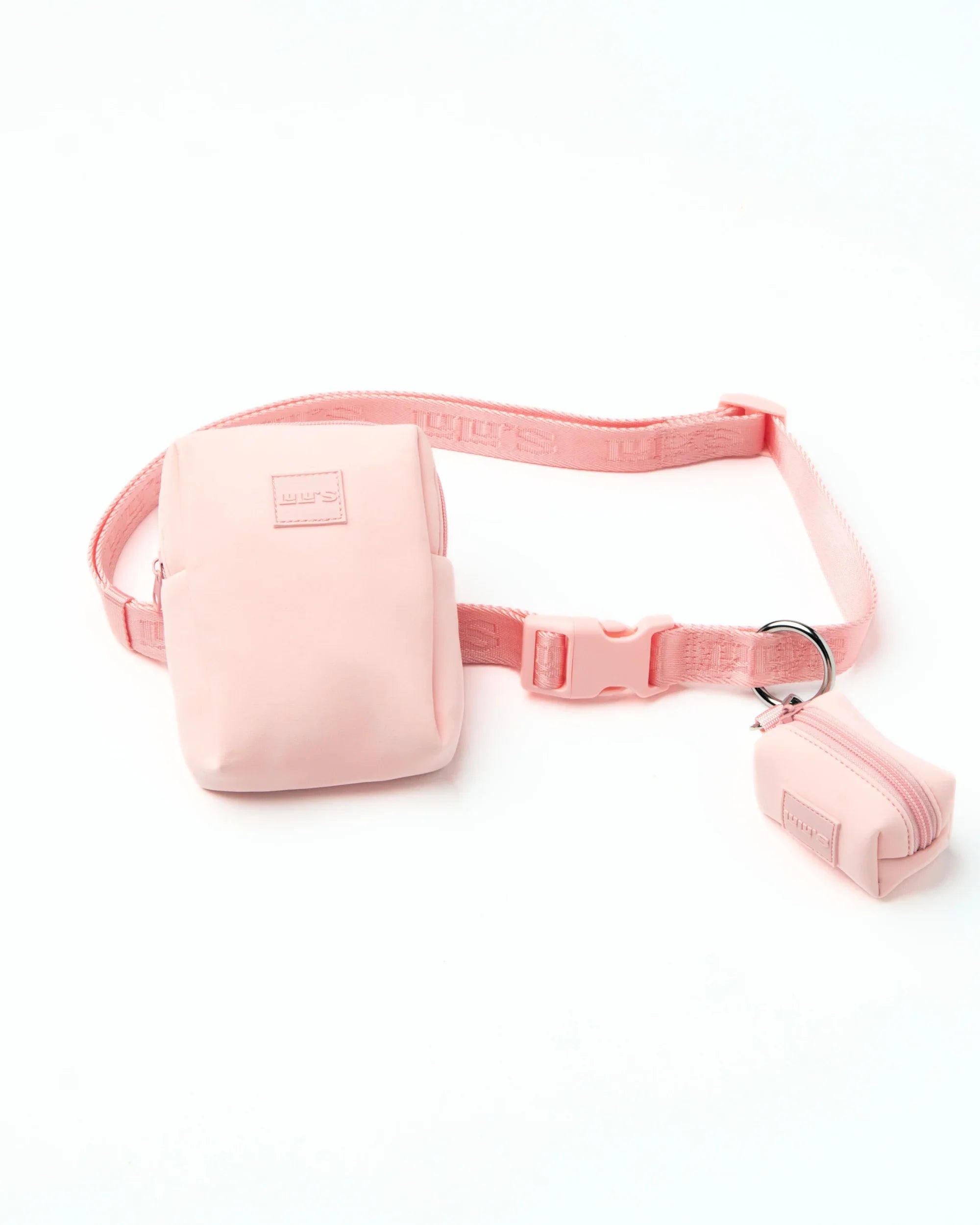 Light pink dog walking set including a matching treat pouch and waste bag holder, connected by a pink adjustable belt with a plastic buckle, laid flat on a white background.
