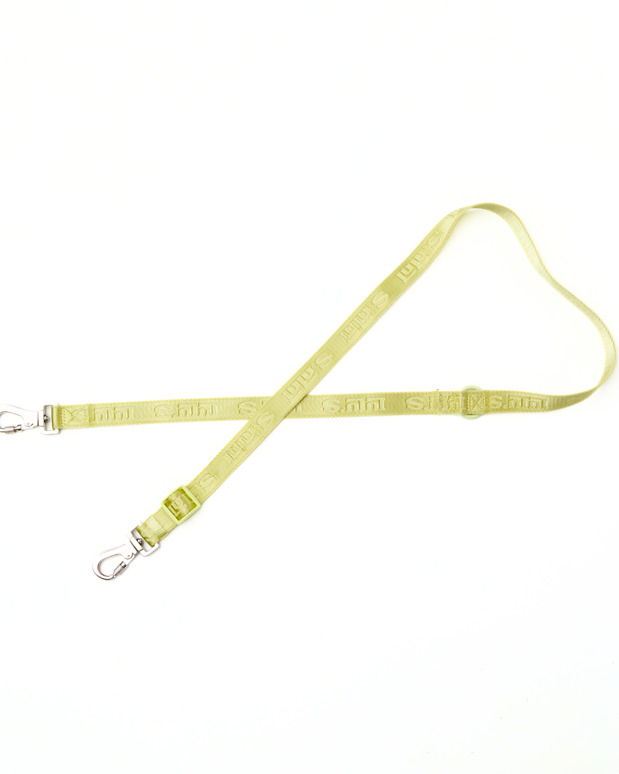 A Matcha Green Lulu's adjustable dog leash with metal clips on both ends, featuring the brand's logo and a durable design, laid out flat.