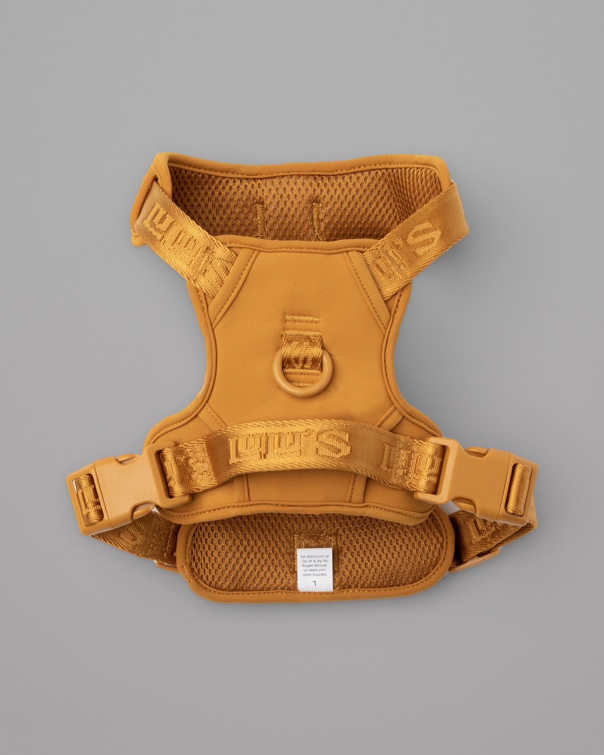 Sand Orange LULU’S from Cali adjustable dog harness, back view on a grey studio background