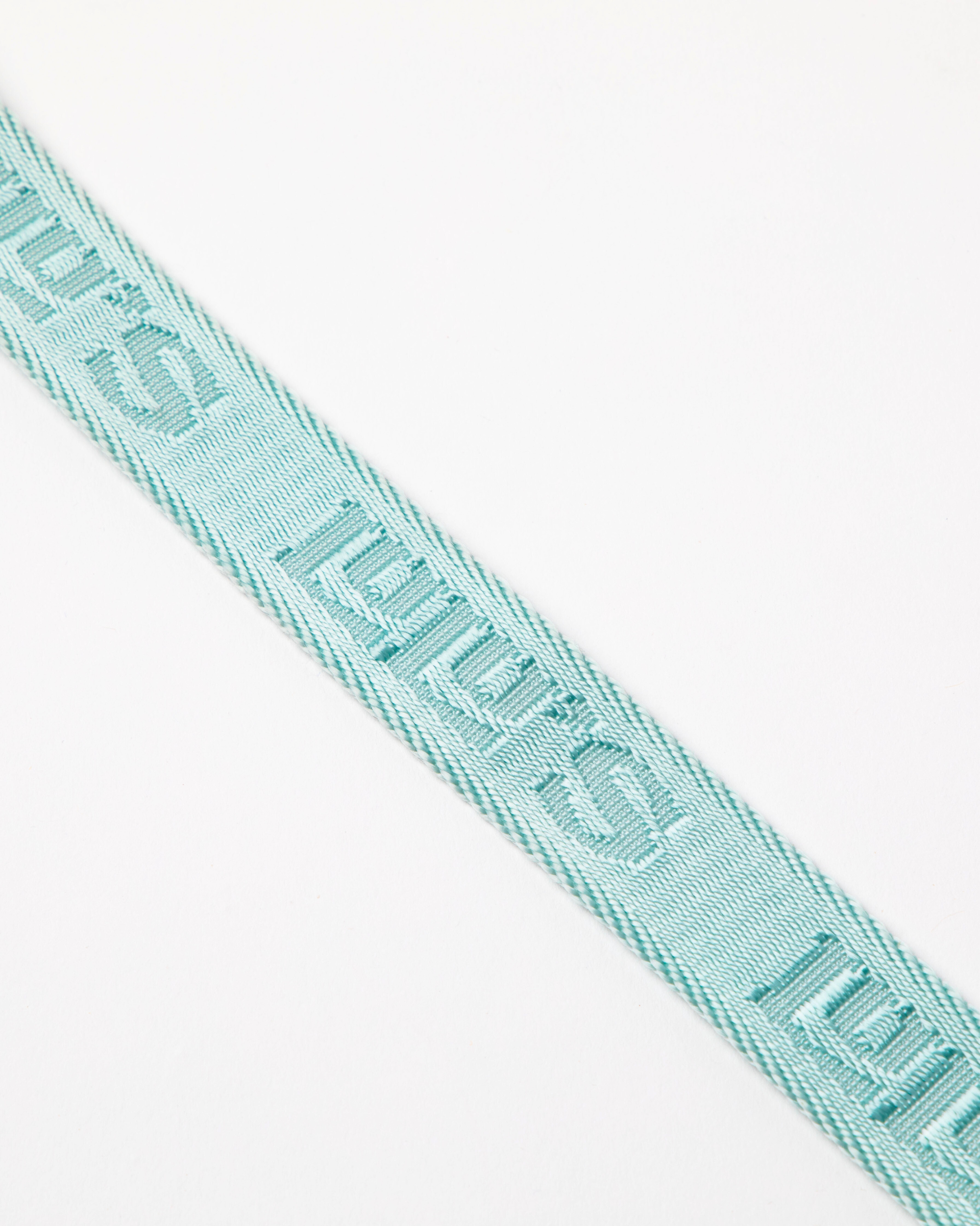 Close-up of a Cali Blue dog leash strap, featuring the Lulu's brand logo embossed in the material